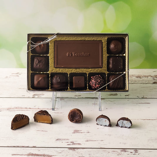 Honor your favorite educator with our 9-piece #1 Teacher Candy Box! Inside, a beautifully crafted milk chocolate card that says "#1 Teacher" is surrounded by an exquisite selection of milk and dark chocolate soft center creams, indulgent truffles, and delightful caramels. It's the perfect way to show your gratitude and make their day truly special!