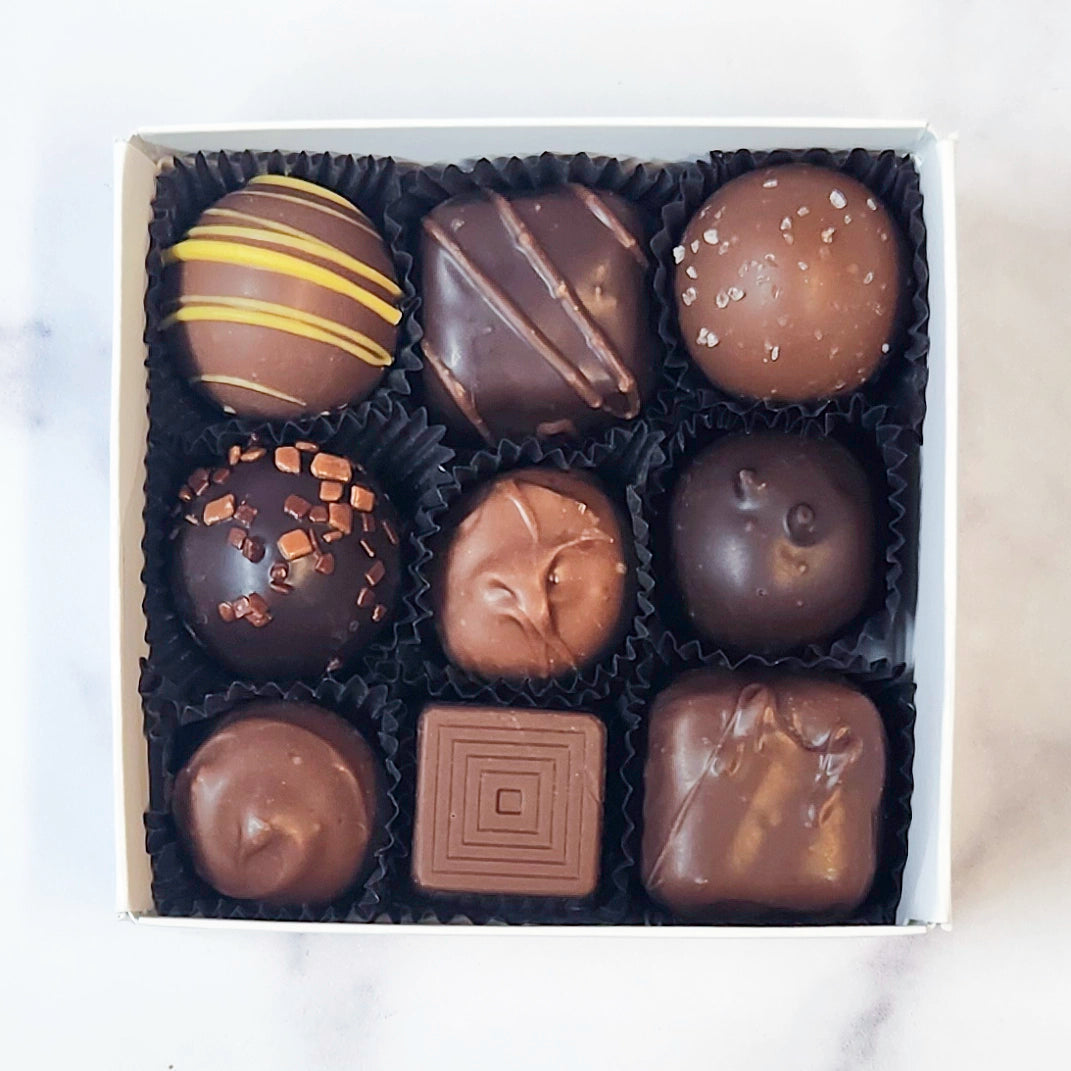 Assorted chocolates in a box on a white background
