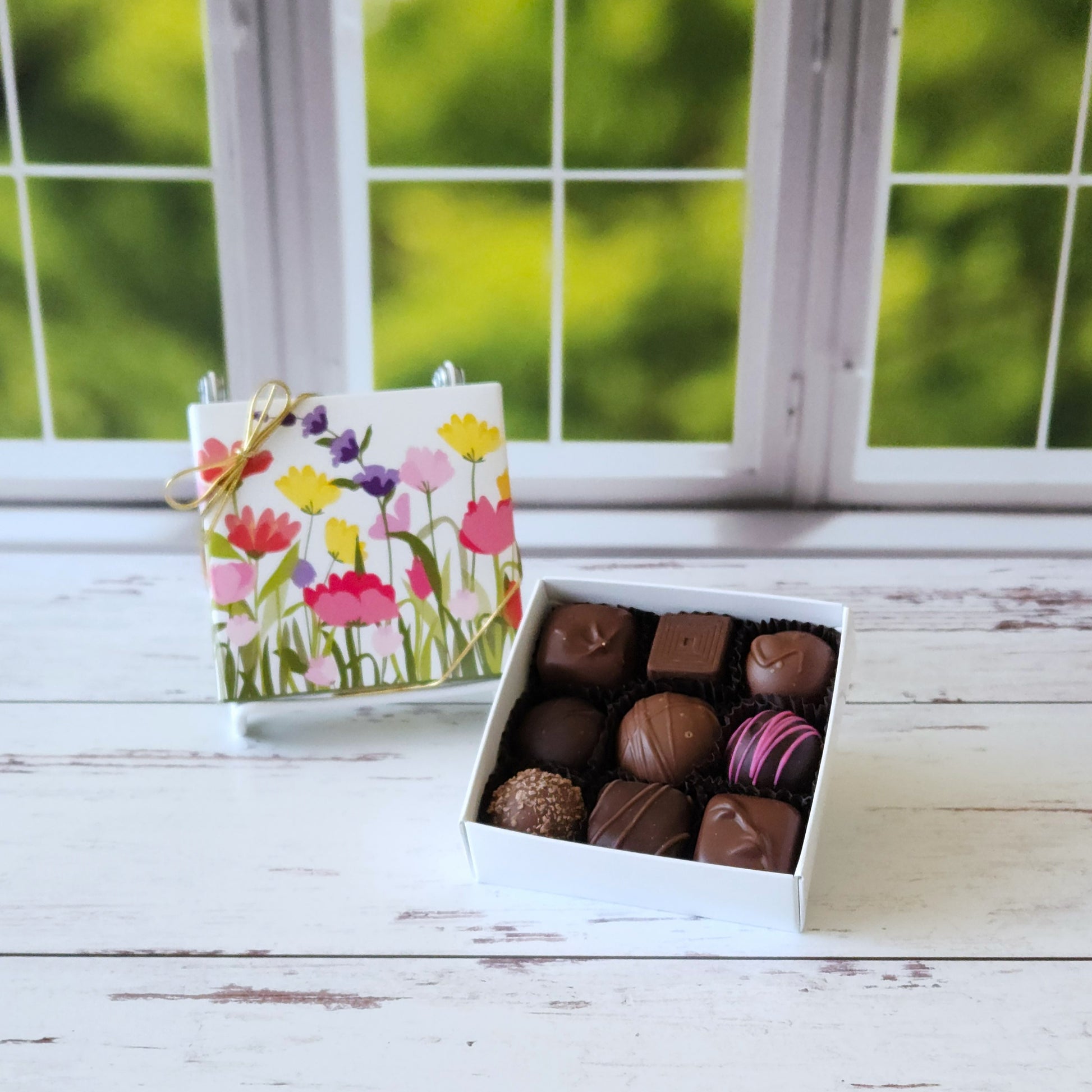 Spring flowers decorate the cover of this 9 piece Milk and Dark Chocolate Assortment. The box is filled with Creams, Caramels, Meltaways and Truffles.