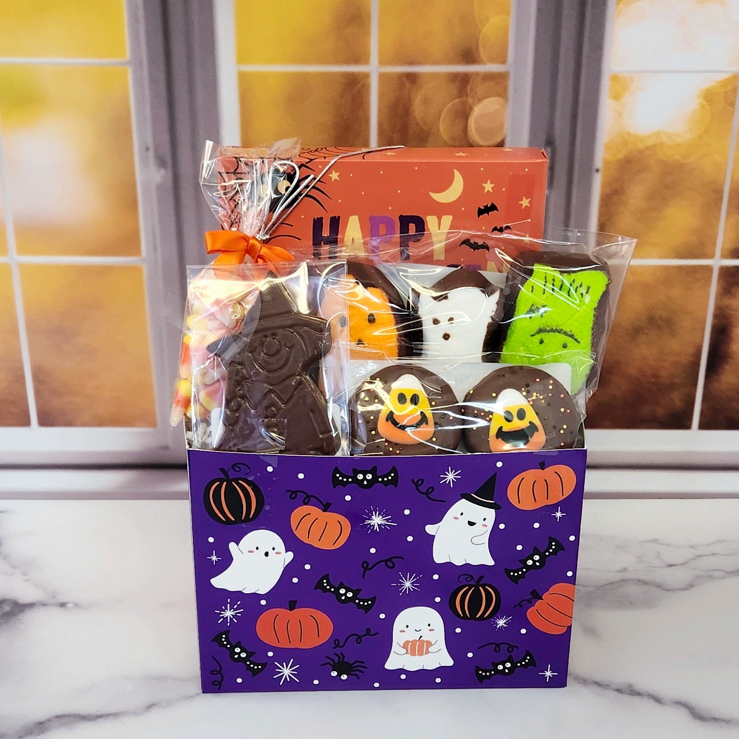 Halloween Boo Gift Basket.
Inside this fun Halloween themed basket you will find Candy Corn, a Milk Chocolate Witch, Halloween Chocolate-Covered Oreos, Chocolate-Covered Peeps, and a 16-Piece Happy Halloween Chocolate Assortment (creams, caramels, melt-aways, truffles)