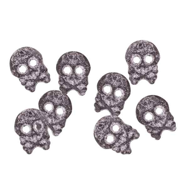 Set of eight small skull-shaped gummies on a white background