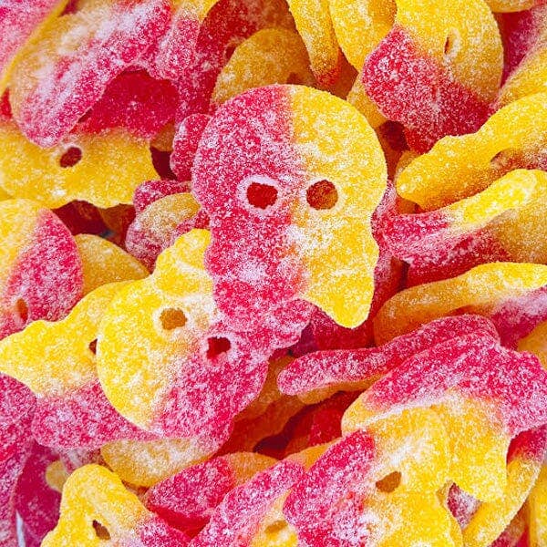 Close-up of pink and yellow gummy skulls.