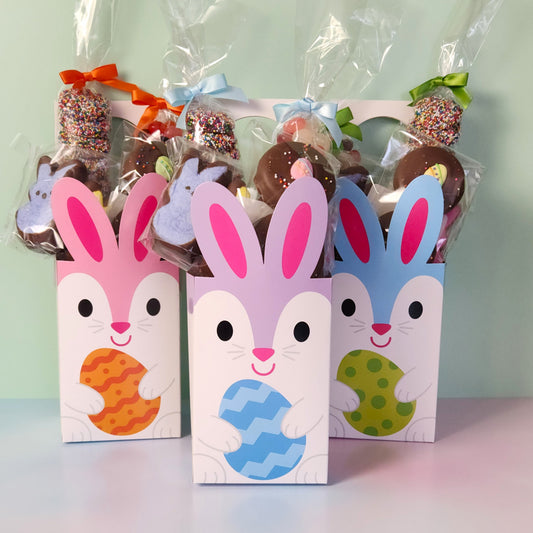 Bunny Door Hanger Gift Basket.
Inside you will find Jelly Beans, Milk Chocolate Nonpareils, Milk Chocolate Oreos dressed up with an Easter sugar decoration, and Chocolate Covered Peeps!
The box is designed to hang on a door knob.