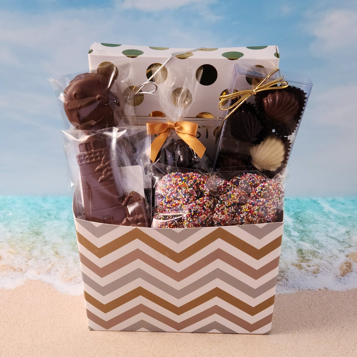 Chevron Cape Cod themed gift basket
Filled with
16-Piece Milk & Dark Chocolate Popular Assortment, Milk Chocolate Lighthouse, Milk Chocolate Covered Oreos, Milk Chocolate Nonpareils,
Dark Chocolate Covered Cranberries and a chocolate Shell Sampler (10 Pieces).
Overwrapped and tied with a beautiful bow perfect for gifting.