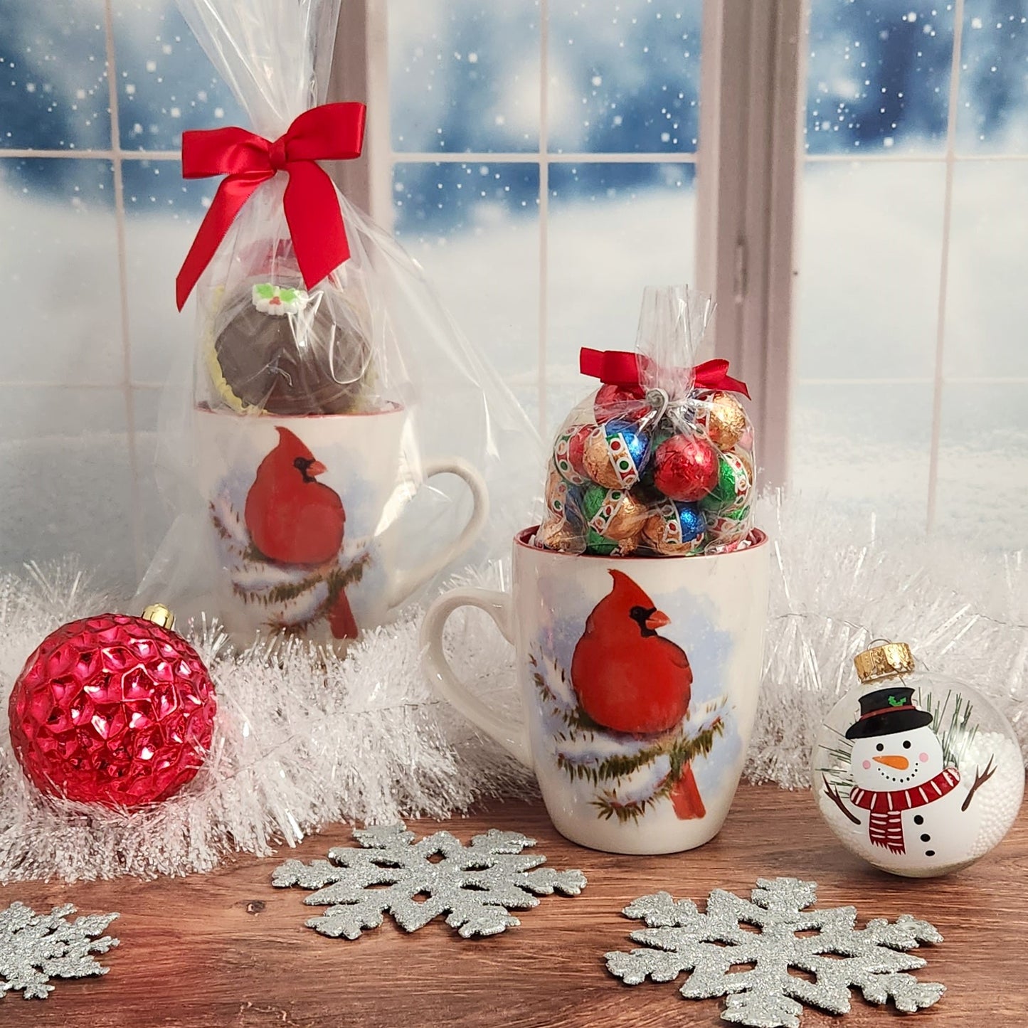 Delightful Cardinal Winter Mug Set - Enjoy 4 oz. of Milk Chocolate from Stage Stop Candy with their signature Foiled Ornaments and Hot Cocoa Bomb, perfect for a relaxing winter night.
