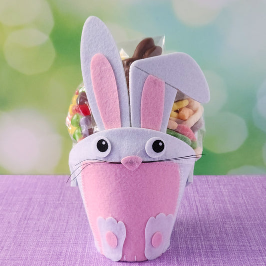 This adorable felt bunny-shaped basket is filled with a delicious assortment of Chocolate-Dipped Marshmallow Peeps, fruity Jelly Beans, Sanded Gummi Bunnies, and a Chocolate Bunny Favor. Wrapped in overwrap and finished with a beautiful bow