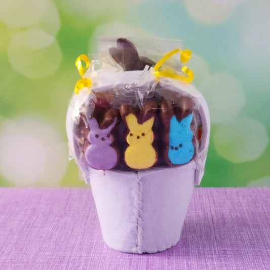 This adorable felt unicorn-shaped basket is filled with a delightful mix of Chocolate-Dipped Marshmallow Peeps, fruity Jelly Beans, Sanded Gummi Bunnies, and a Chocolate Bunny Favor. Wrapped in overwrap and finished with a beautiful bow