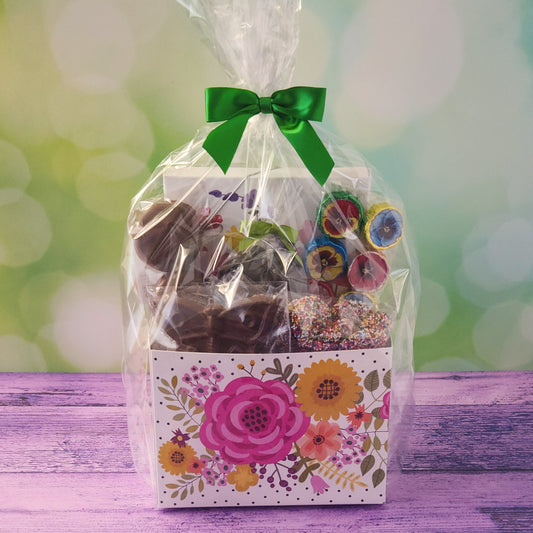 Surprise someone special with our Floral Gift Basket, a beautifully curated selection of chocolates and sweet treats presented in a vibrant floral-themed box.
Inside, you'll find a decadent 16-piece chocolate assortment, Milk Chocolate Foiled Flowers, Two Chocolate-Covered Oreos, Dark Chocolate-Covered Cranberries, Milk Chocolate Nonpareils and A Beautiful Milk Chocolate Butterfly.
Wrapped with a bow and ready to gift!
