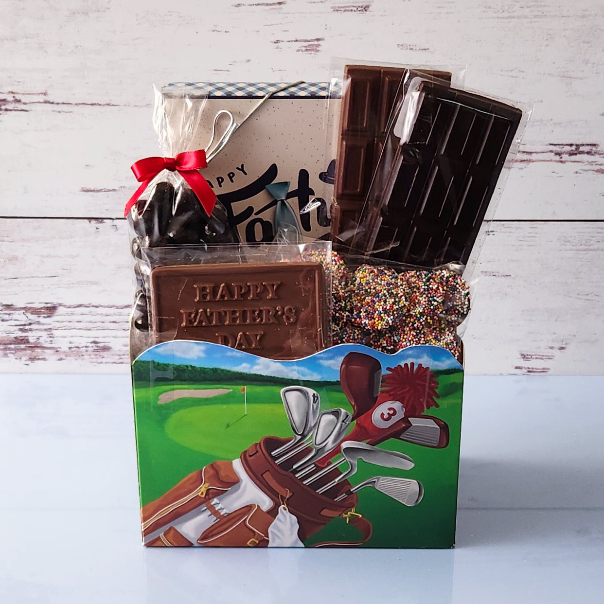 This golf style basket is filled with all of dads favorite candy. From Chocolate bars, to nonpareils and even chocolate covered cranberries fill this basket.