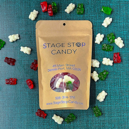 Gummi Christmas Bears, top-down view of the kraft Stage Stop bag lying flat on teal, ringed by red, white and green bears