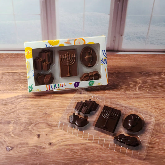 Celebrate the joy of Hanukkah with our festive Hanukkah Chocolate Box Set! This delightful assortment features solid chocolates shaped like traditional holiday symbols, including dreidels, menorahs, and more. Choose from smooth milk chocolate or rich dark chocolate to suit your taste.