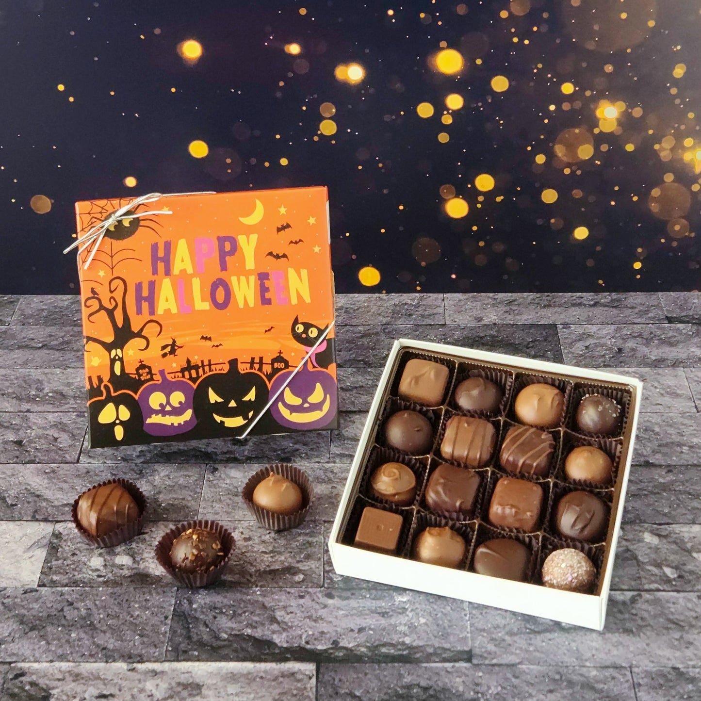 This Happy Halloween Assortment is available in 9-piece or 16-piece boxes, featuring a mix of milk and dark chocolate truffles, creams, caramels, and meltaways.