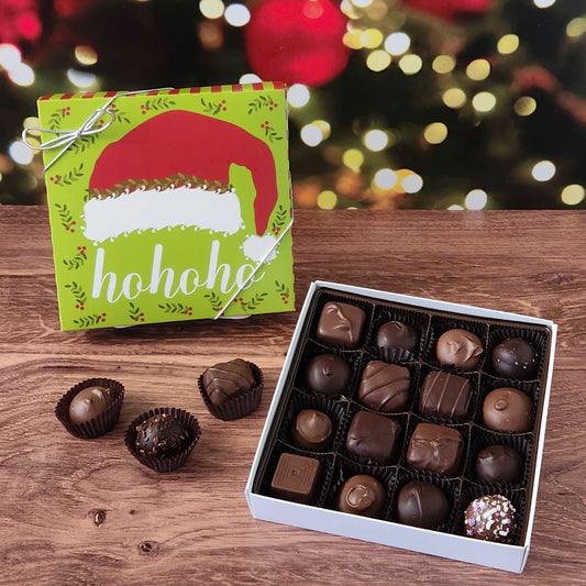 16 piece chocolate assortment box with ho ho ho Santa hat Christmas themed box. Filled with a variety of creams, caramels, melt-aways and truffles.