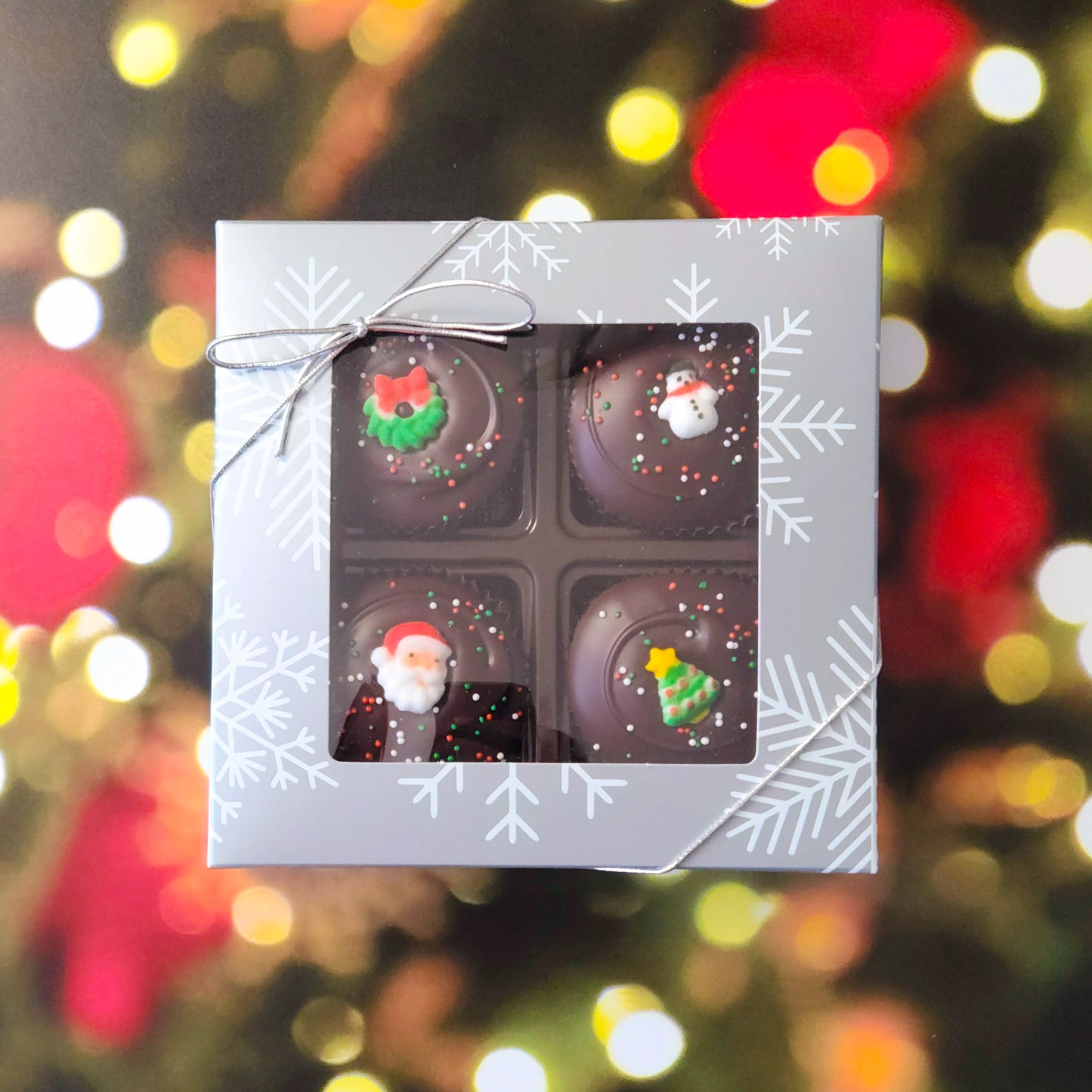 Surprise someone special with our Winter Holiday Peanut Butter Cup Gift Box! This delightful four-piece selection features handcrafted peanut butter cups, covered in rich dark chocolate, and topped with adorable sugar decorations for a festive touch