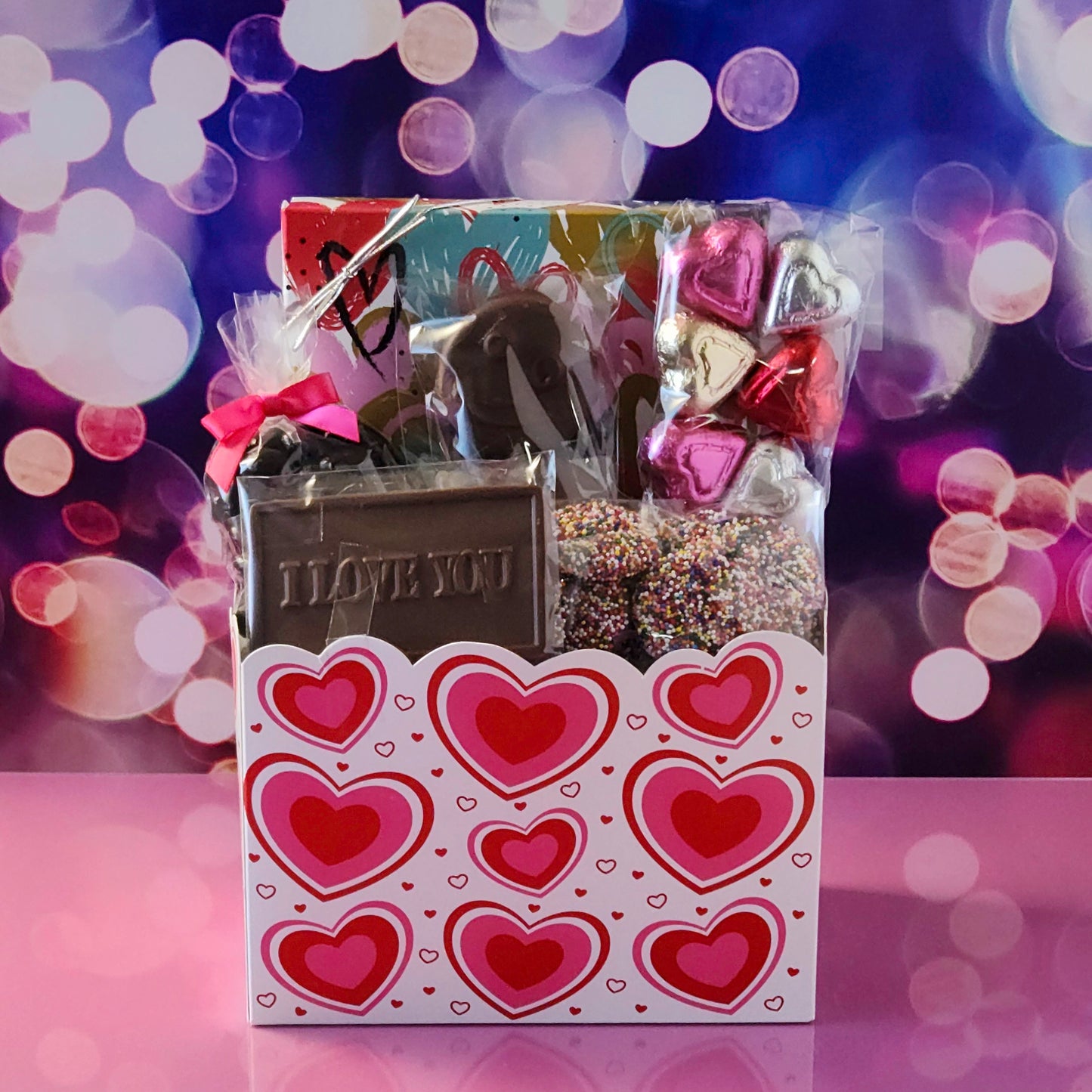 Make this Valentine’s Day unforgettable with our Valentine’s Day Gift Basket featuring:
Dark Chocolate Covered Cranberries, Milk Chocolate Oreos , Milk Chocolate Nonpareils, Milk Chocolate Foil Hearts, A 16-piece Assortment and a charming Milk Chocolate Card that says I Love You, the sweetest way to express your feelings.