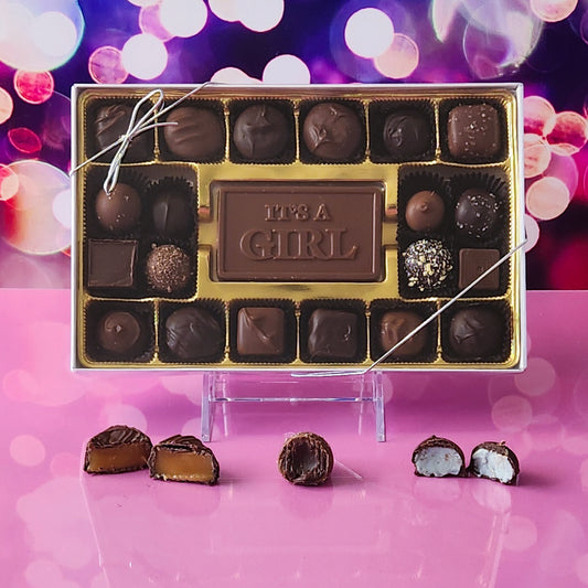 Welcome the new arrival with our 20-piece It's a Girl Candy Box! Inside, a beautifully crafted milk chocolate card that says "It's a Girl" is surrounded by an irresistible assortment of milk and dark chocolate soft center creams, decadent truffles, and luscious caramels. It's the perfect way to celebrate and share the joy of this special occasion!