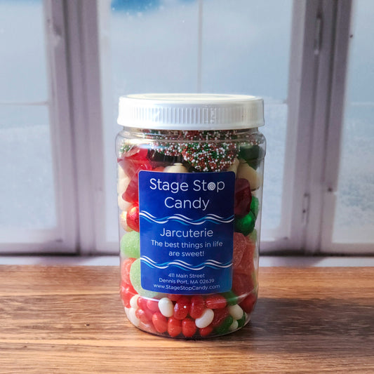 Our Christmas Jarcuterie jars are a festive treat and the perfect gift for spreading holiday cheer! Each jar is packed with delicious layers, beginning with a bed of red, green, and white jelly beans, followed by a colorful layer of jolly Jingle Bell jells. Next come our multi-colored milk chocolate “ornaments,” adding a creamy touch of chocolate to the mix, followed by a fun layer of snowman and tree gummies. To finish, we’ve topped each jar with delightful milk chocolate Christmas nonpareils.