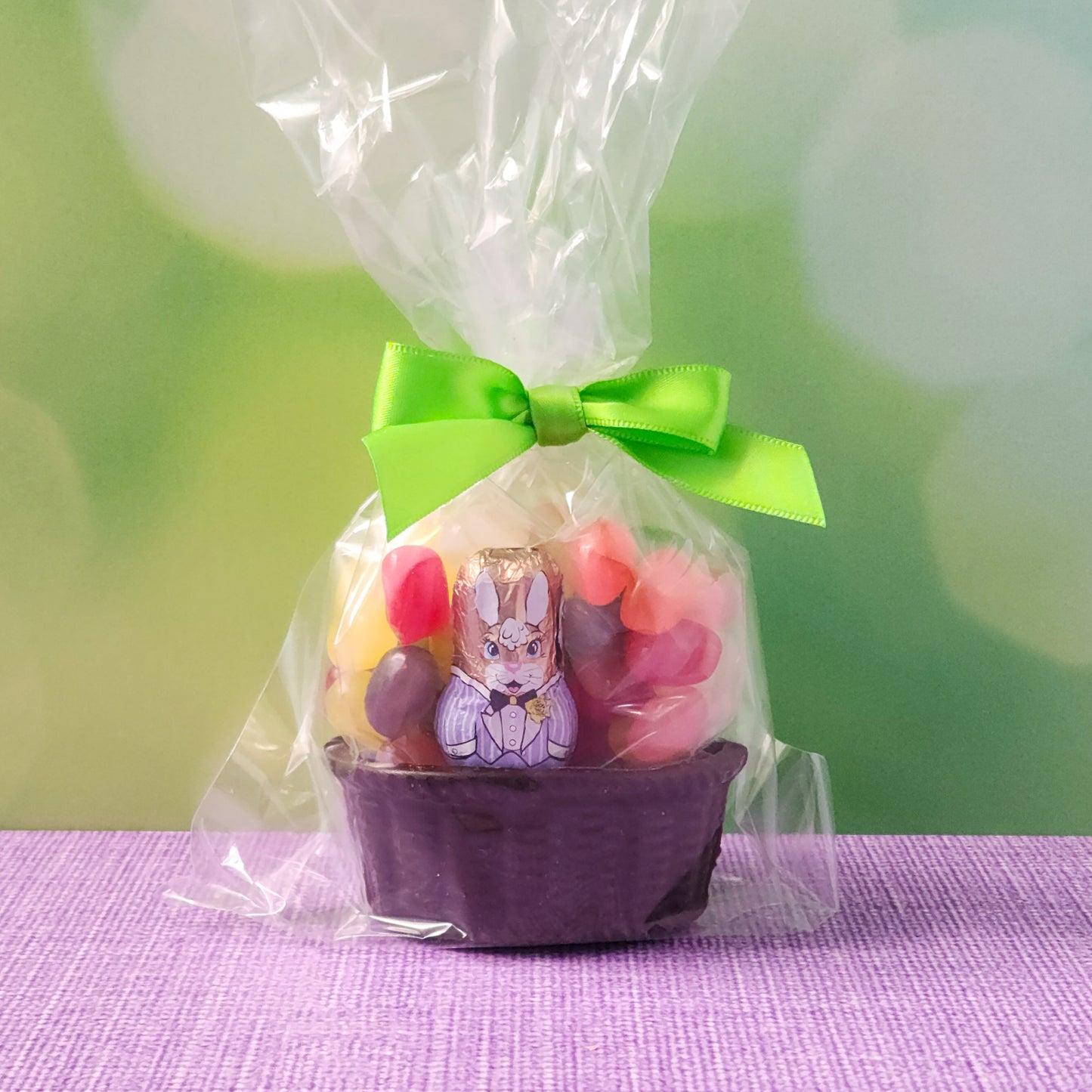 Edible dark chocolate basket filled with jelly beans and a milk chocolate foiled bunny.