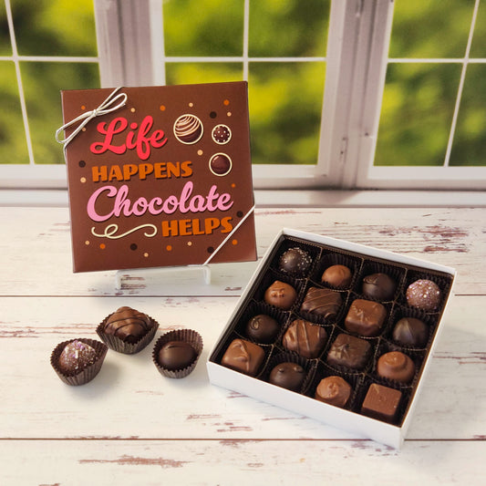 This handcrafted Mix of Milk & Dark Chocolate Popular Assortment is available in a 9‑piece or 16‑piece box with a playful “Life Happens, Chocolate Helps” message on the cover - perfect for brightening someone’s day or treating yourself. Inside, you’ll find an irresistible assortment of creams, caramels, melt‑aways and truffles.