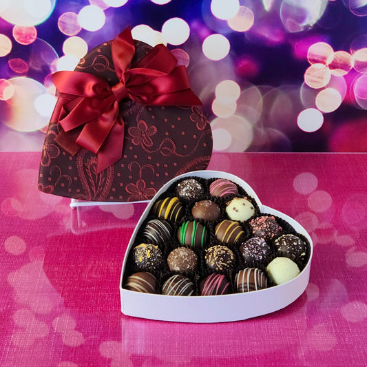 Give the ultimate gift of love this Valentine’s Day with our Truffle Heart, a luxurious assortment of handcrafted chocolate truffles. This 19 piece heart-shaped box is filled with an irresistible variety of creamy, decadent truffles. From classic flavors to unique creations, every bite is a delightful surprise that’s sure to melt hearts