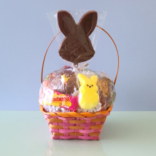 Each basket contains a marshmallow peep, Easter gummies, a chocolate covered Easter Oreo, Easter Egg malt balls, jelly beans, a foiled chocolate bunny, yummy kids candy and is topped off with a smiling chocolate bunny pop. We finish the basket with overwrap and a bow so that it is ready to gift!