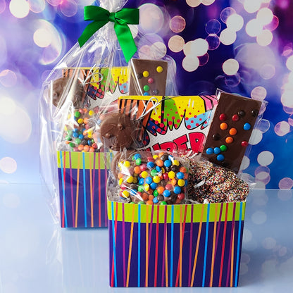 Super Hero themed gift basket filled with a milk and dark chocolate assortment, chocolate dipped oreos, an M&M pretzel, nonpareils and a milk chocolate fun bar. , 