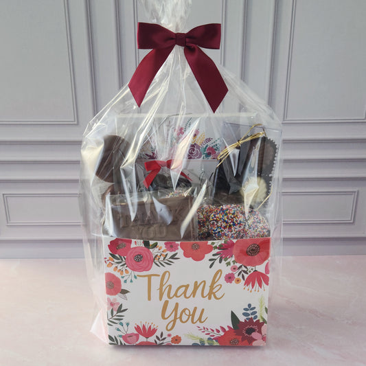 This Floral Thank You Gift Basket is filled with a variety of delicious treats, including:
Milk Chocolate Covered Oreos, Milk Chocolate Nonpareils, A "Thank You" Milk Chocolate Bar, Chocolate Shell Sampler Box and a 16-Piece Milk and Dark Chocolate Assortment.
Perfect for coworkers, teachers, clients, friends, or anyone who deserves a sweet token of appreciation, this basket is sure to leave a lasting impression!