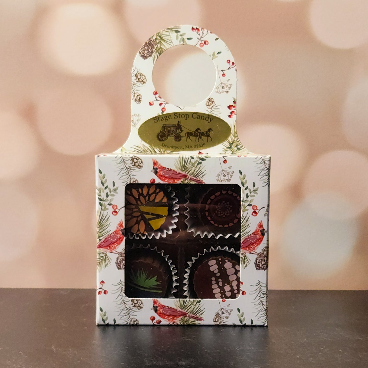 Our Stage Stop Select 4-Piece Truffle Box This charming set includes four handcrafted chocolate truffles in milk chocolate and dark chocolate.
Packaged in an elegant box that securely hangs from the neck of a wine, champagne, or a soda bottle, this gift set instantly transforms any bottle into a ready-to-give present. Bring a sweet touch to every toast.