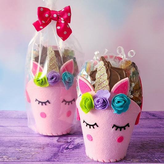 A pretty pink Unicorn Gift Basket filled with magical candy treats.
