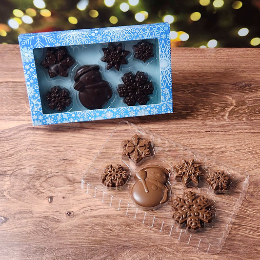 Step into a chocolatey winter wonderland with our Winter Fun Chocolate Gift Box! This festive set features a charming solid chocolate snowman and five beautifully detailed chocolate snowflakes, creating a perfect seasonal treat. Available in Milk or Dark Chocolate