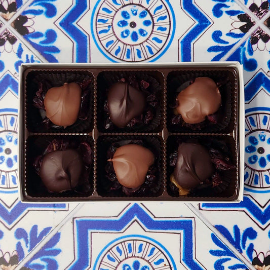 A seasonal favorite. Dried cranberries are surrounded by delicious caramel and topped with Milk chocolate or Dark chocolate. This 6 piece box features 3 Cranberry Caramel Clusters capped with Milk chocolate and 3 with Dark chocolate.