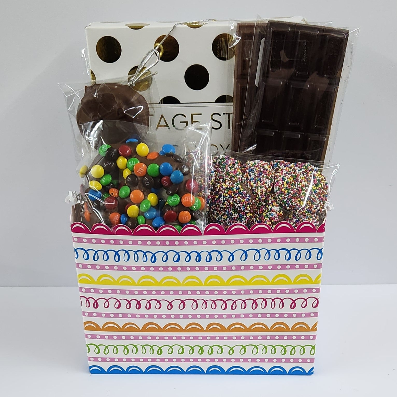 Sweet Swirls Gift Baskets includes a 16-piece assortment of creams, caramels, meltaways and truffles, milk & dark chocolate candy bars, milk chocolate covered Oreos, milk chocolate nonpareils and a milk chocolate covered pretzels coated in mini M & M's. 