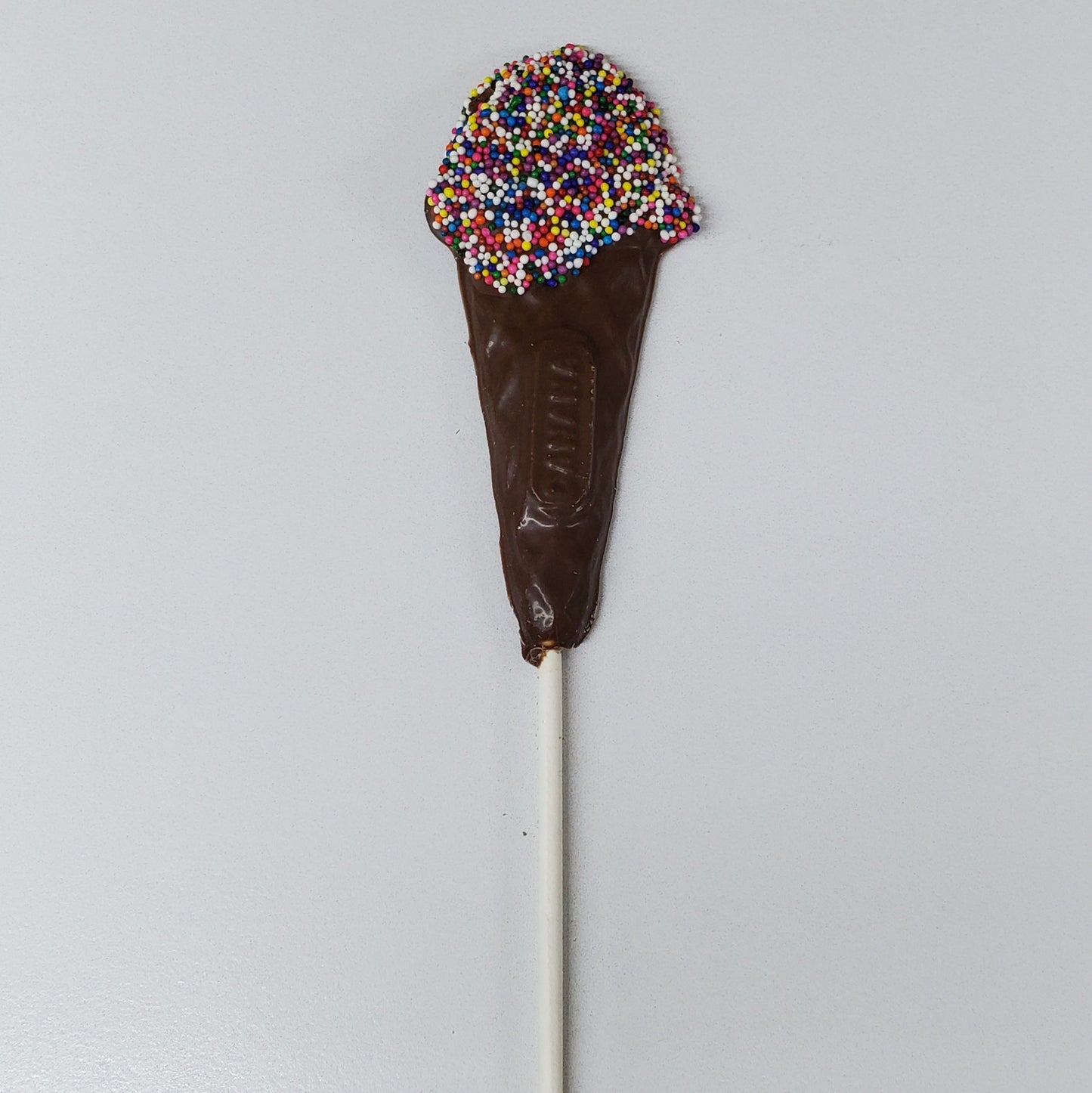 Milk Chocolate shaped into an ice cream cone with rainbow nonpareils