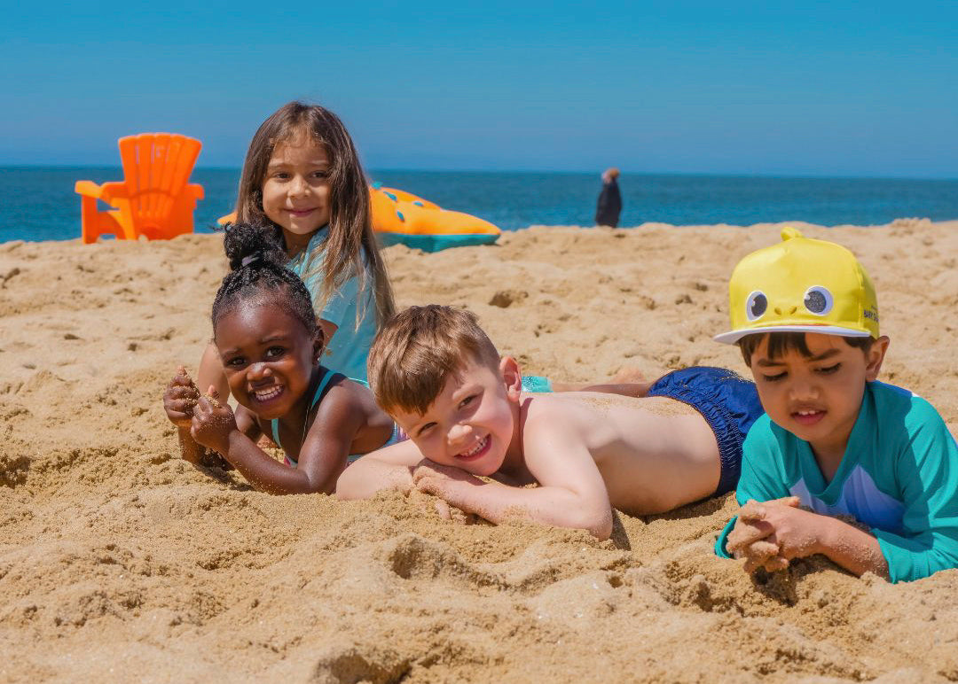 Kids playing on a Cape Cod beach in Dennis MA on a sunny summer day