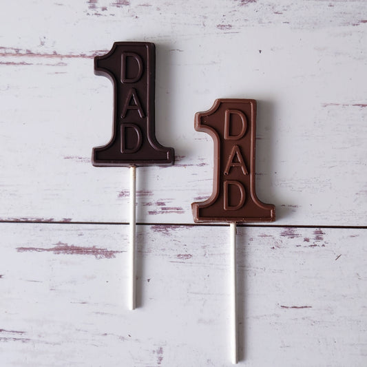 Surprise Dad with our #1 Dad Chocolate Lollipop! Shaped like the number 1 and featuring the word "Dad," this delicious treat is a fun and thoughtful gift for Father's Day. Made from rich, creamy chocolate, it's the perfect way to show your dad he's the best!