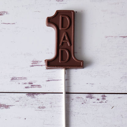 Celebrate Father's Day with our #1 Dad Milk Chocolate Lollipop! Shaped like the number 1 and featuring "Dad" on it, this creamy milk chocolate treat makes a fun and delightful gift. It's the perfect way to show your dad he's truly number one! 