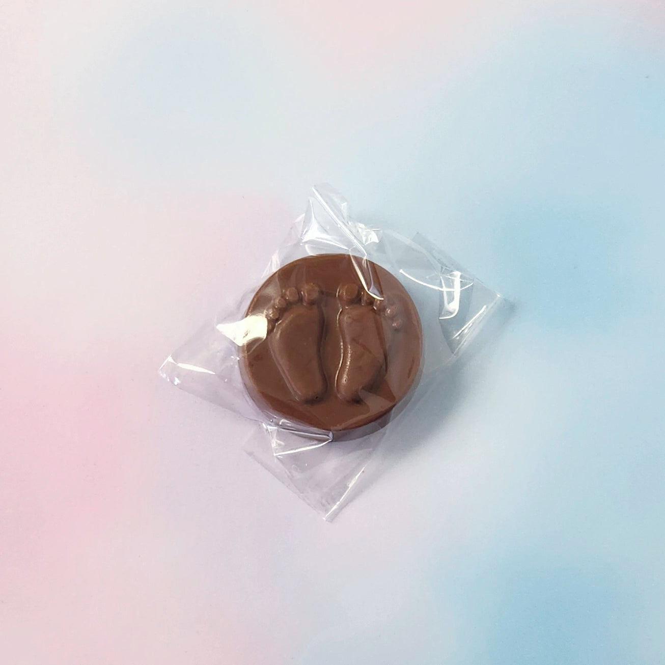 Chocolate mold in clear plastic packaging on a gradient background