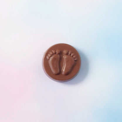 Chocolate circle with footprints on a white background
