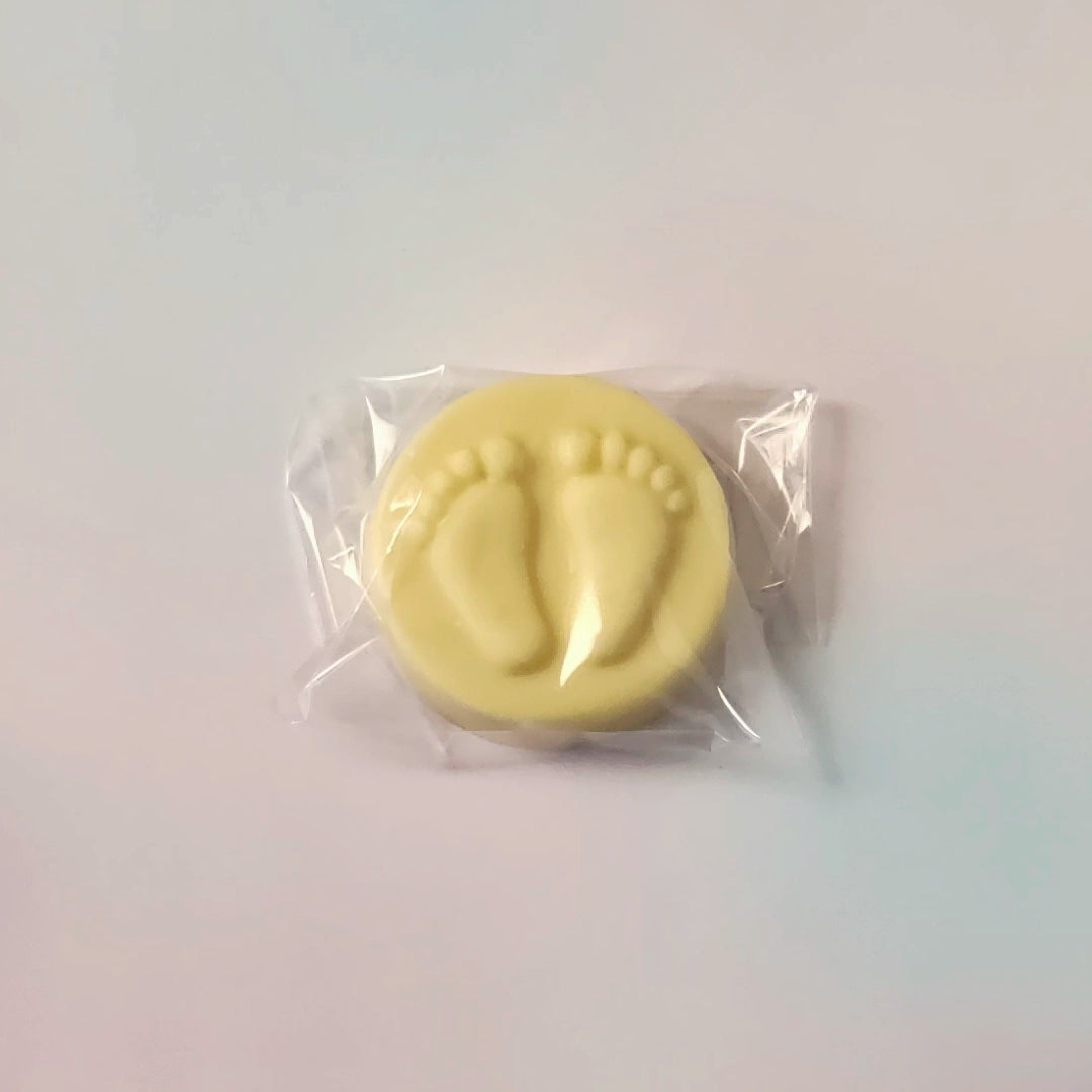 White chocolate with footprints in clear packaging on a white background