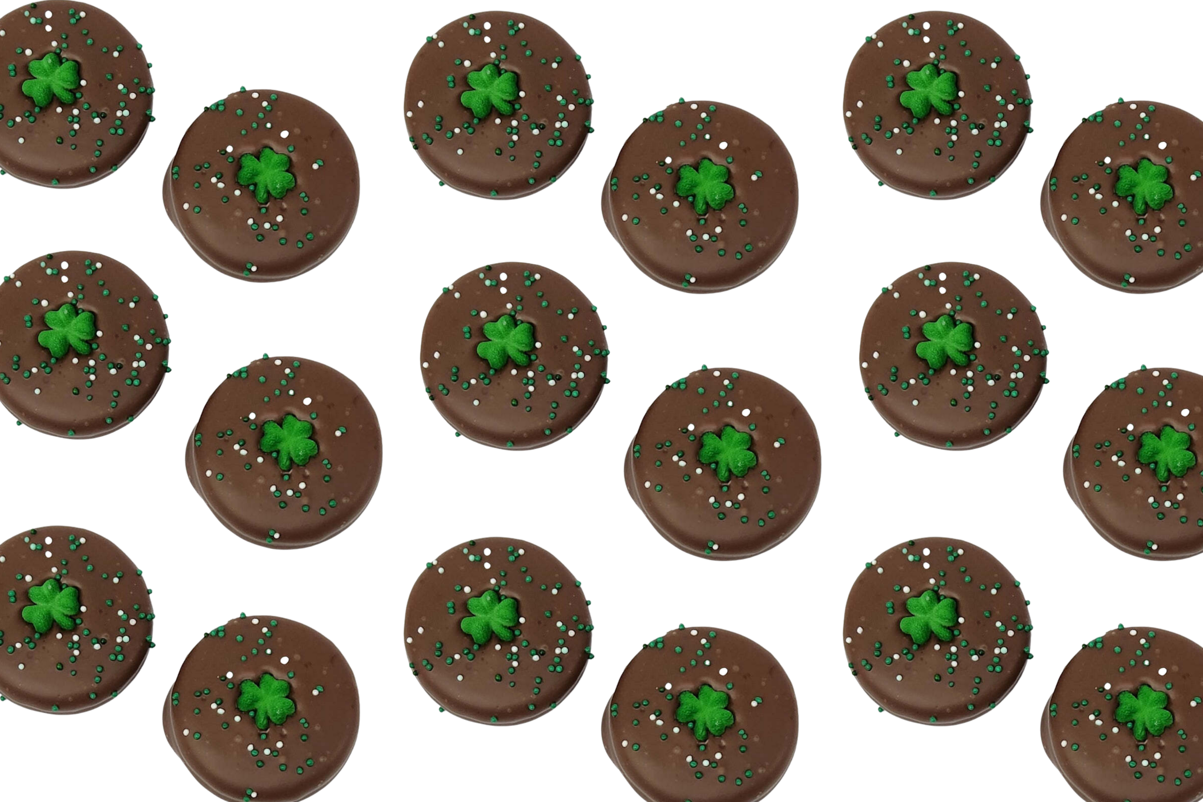 Chocolate-covered Oreos decorated with green shamrocks and festive green and white nonpareils, perfect for St. Patrick’s Day treats.