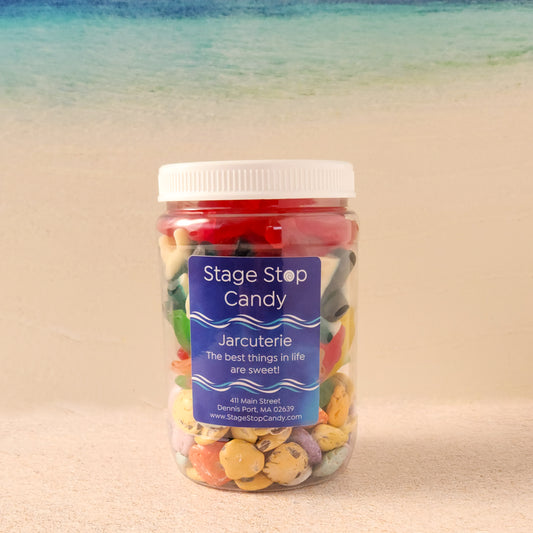 Dive into summer with our Beach Day Jarcuterie, a fun and festive mix of ocean-inspired treats! Packed in a resealable jar, this delicious assortment includes Milk Chocolate Shells, Assorted Swedish Fish, Gummi Sharks, and Gummi Lobsters—the perfect way to bring the beach to you! Whether you're lounging by the water, hosting a summer party, or just craving a taste of seaside fun, this candy-filled jar is sure to make waves.