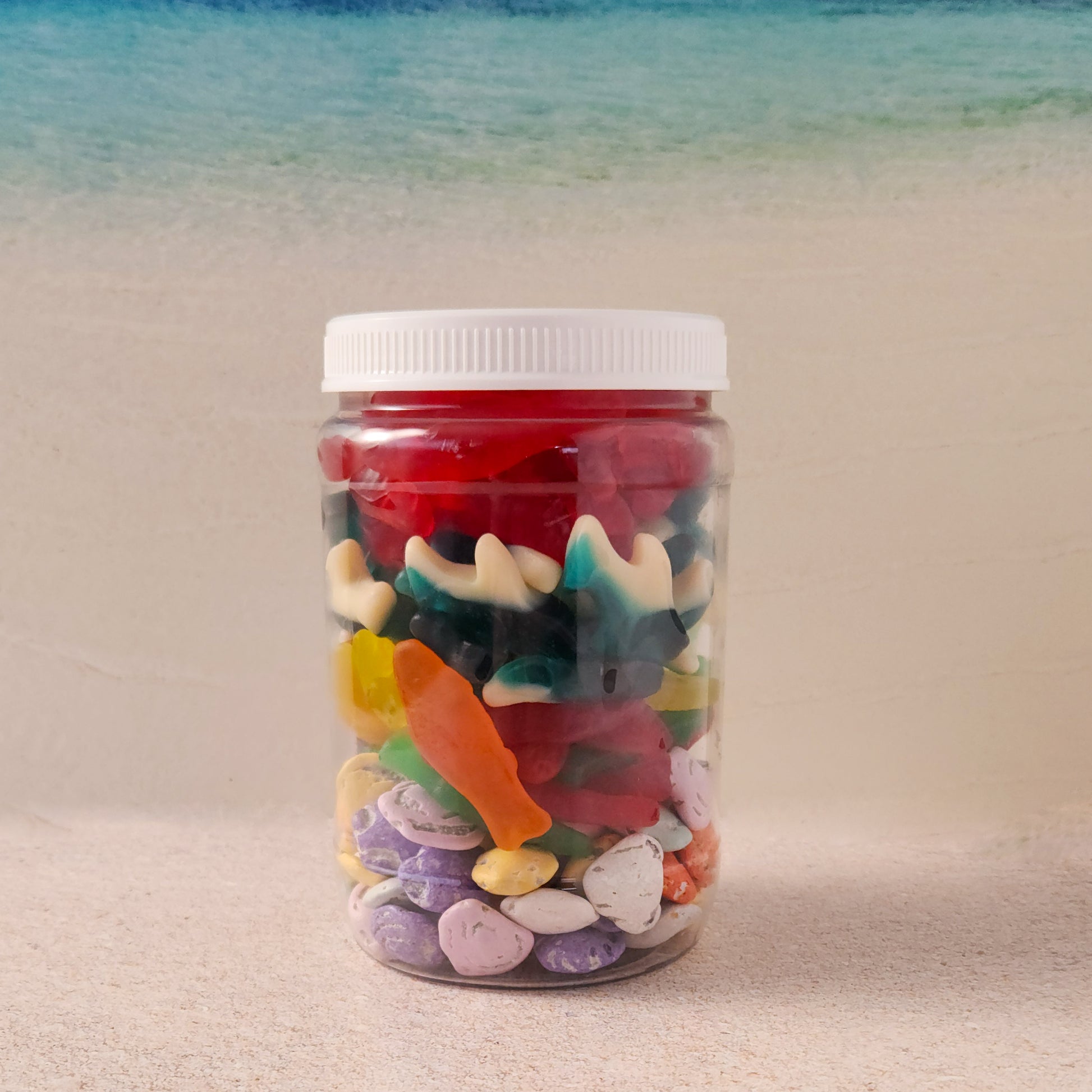 Dive into summer with our Beach Day Jarcuterie, a fun and festive mix of ocean-inspired treats! Packed in a resealable jar, this delicious assortment includes Milk Chocolate Shells, Assorted Swedish Fish, Gummi Sharks, and Gummi Lobsters—the perfect way to bring the beach to you! Whether you're lounging by the water, hosting a summer party, or just craving a taste of seaside fun, this candy-filled jar is sure to make waves.