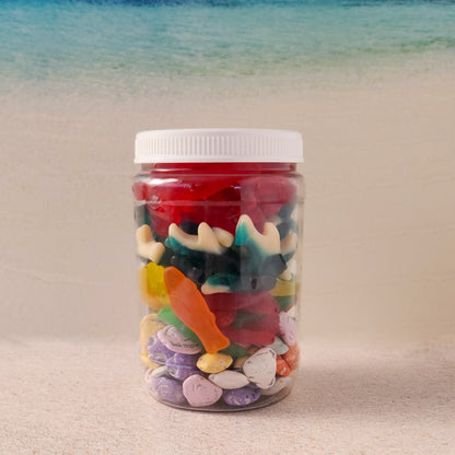 Dive into summer with our Beach Day Jarcuterie, a fun and festive mix of ocean-inspired treats! Packed in a resealable jar, this delicious assortment includes Milk Chocolate Shells, Assorted Swedish Fish, Gummi Sharks, and Gummi Lobsters—the perfect way to bring the beach to you! Whether you're lounging by the water, hosting a summer party, or just craving a taste of seaside fun, this candy-filled jar is sure to make waves.