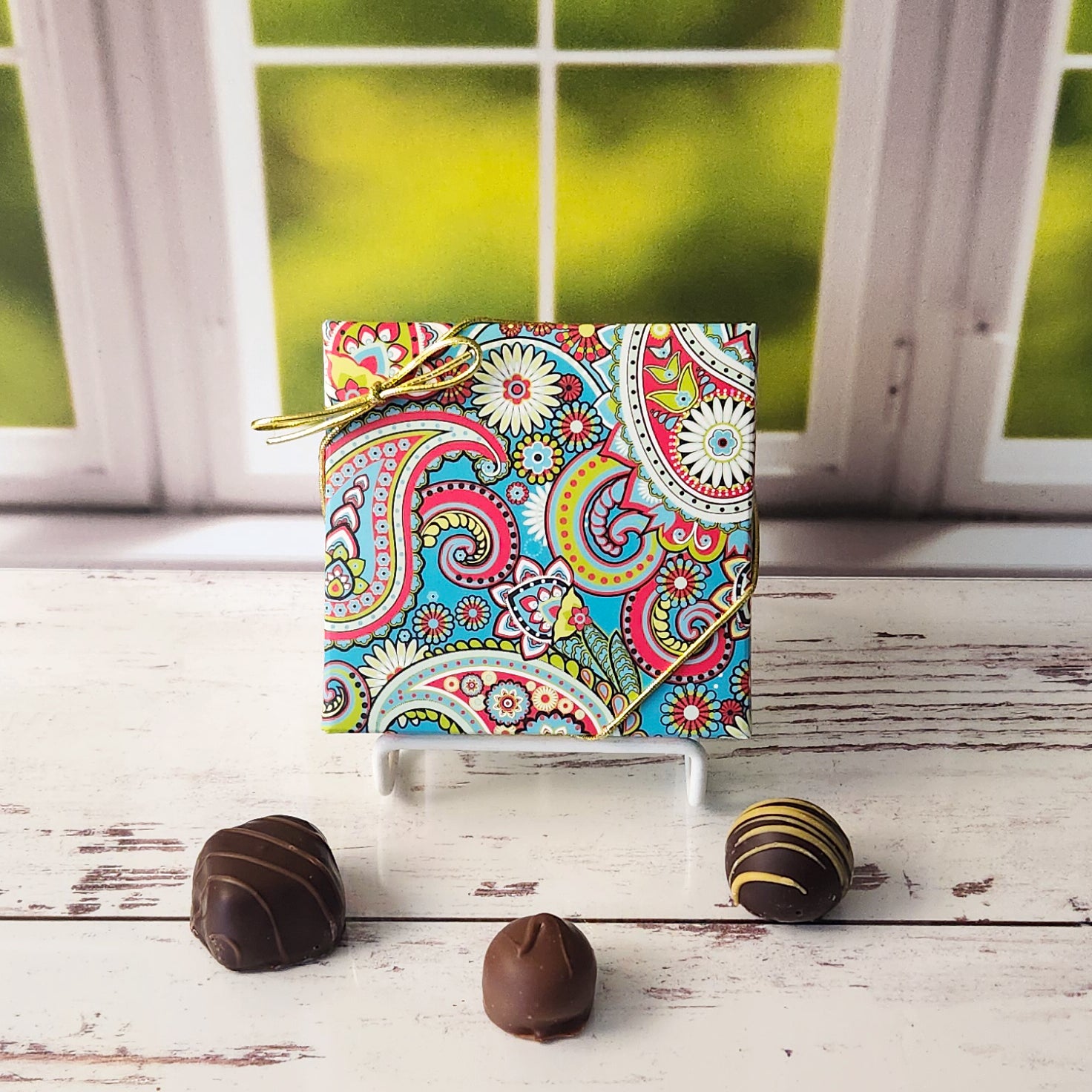 An assortment of our most popular milk and dark chocolate creams, caramels, melt-aways, and truffles all packed inside a bright paisley printed box.