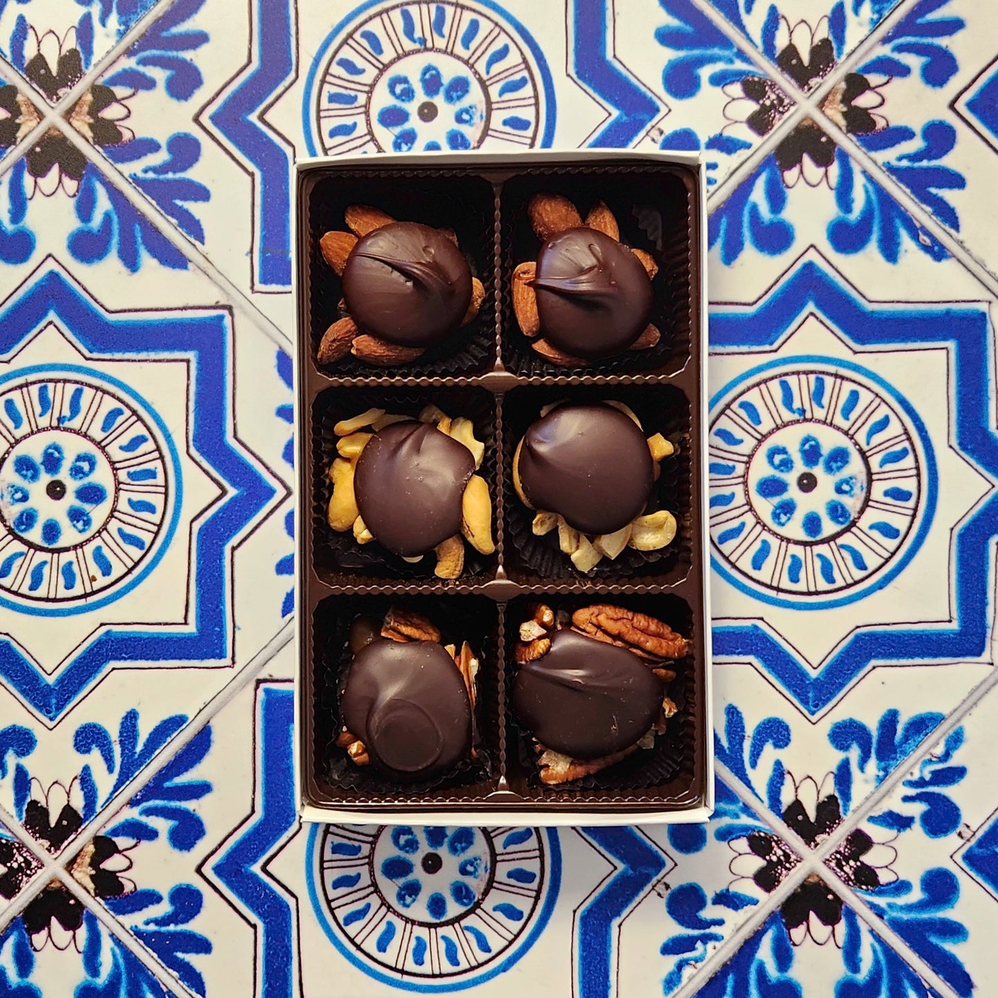 Caramel, nuts, and chocolate come together in a wonderful harmony of flavors. Every piece is made with freshly roasted nuts (almonds, cashews, or pecans), held together with delicious, hand made vanilla caramel and topped with our rich Milk chocolate or Dark chocolate