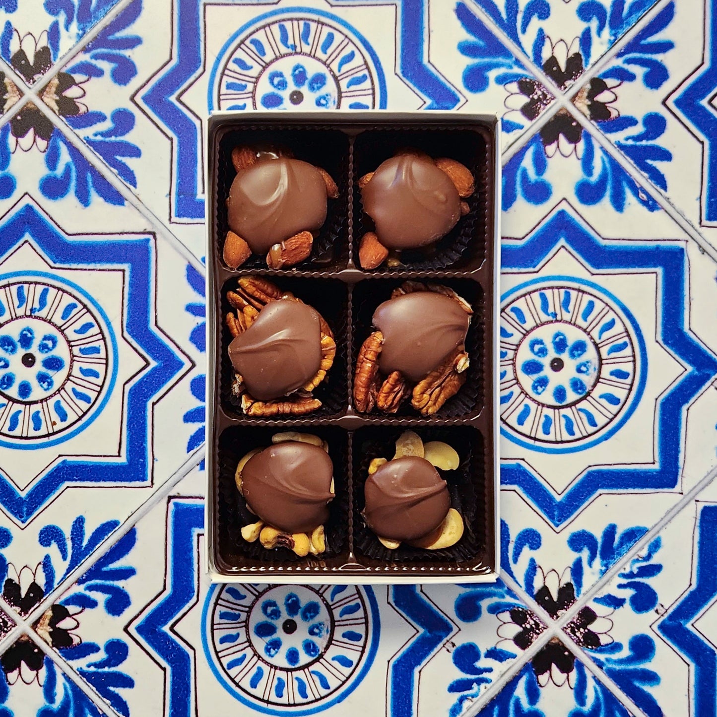 Caramel, nuts, and chocolate come together in a wonderful harmony of flavors. Every piece is made with freshly roasted nuts (almonds, cashews, or pecans), held together with delicious, hand made vanilla caramel and topped with our rich Milk chocolate or Dark chocolate