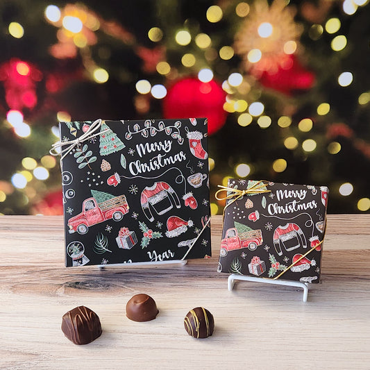 An assortment of our most popular milk and dark chocolate creams, caramels, melt-aways, and truffles all packed inside a box with a festive Chalkboard Christmas theme printed on the lid.