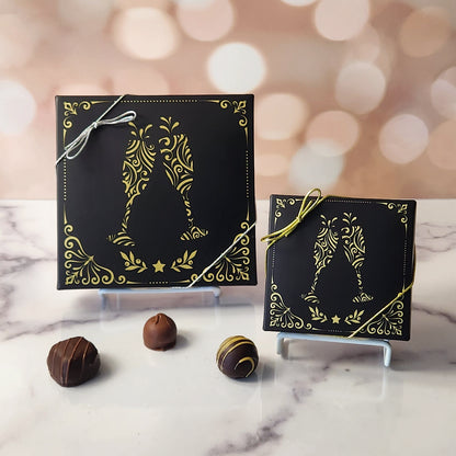 An assortment of our most popular milk and dark chocolate creams, caramels, melt-aways, and truffles all packed inside a festive printed box. The cover of the box features toasting glasses with a gold border