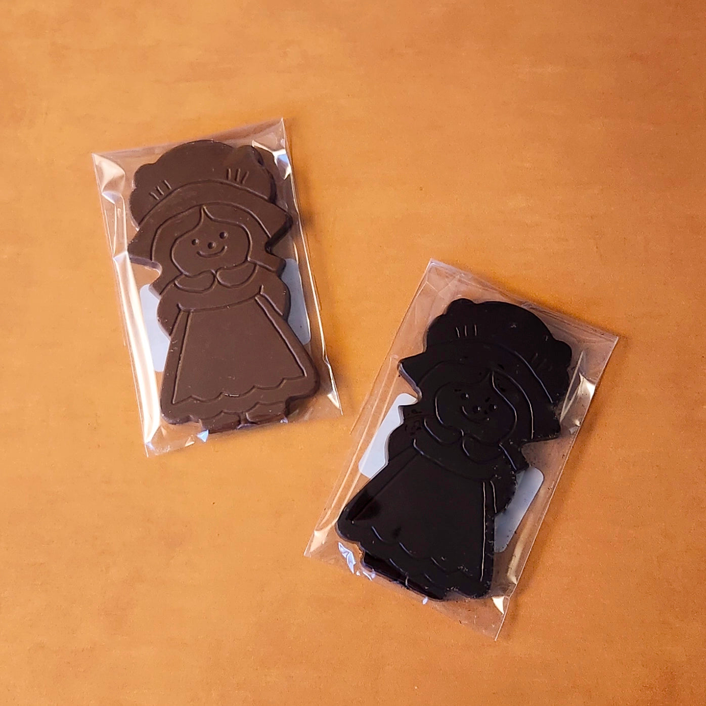 Celebrate Thanksgiving with our charming Girl Pilgrim Chocolate Favor, a delightful addition to any holiday table! Available in smooth milk chocolate or bold dark chocolate, this adorable pilgrim-shaped treat adds a touch of tradition and sweetness to your festivities