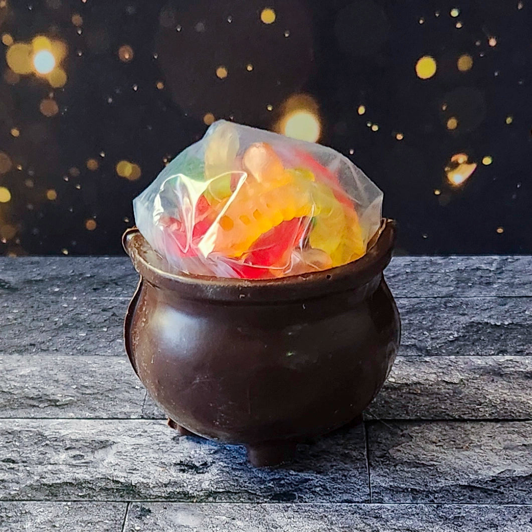 Cast a sweet spell this Halloween with our Chocolate 3D Kettle, crafted from our rich and creamy Dark chocolate. Inside this fun, witchy cauldron, you’ll find a mix of Salt Water Taffy and Gummy Worms. 
Due to its fragile nature, this spooky treat is only available for in-store pick-up.